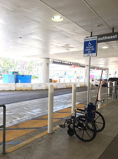 Curb sign designated for loading passengers with a disability